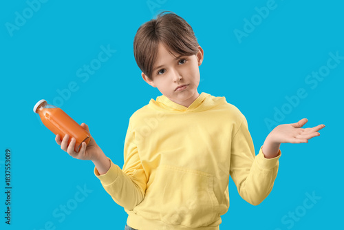Upset little boy with bottl...