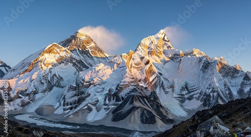 Majestic Himalayan Panorama: Golden Sunrise on Everest, Lhotse, and Nuptse Peaks, with Glaciers and Prayer Flags in the Khumbu Region of Nepal.