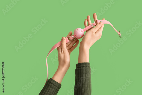 Woman with pink mouth gag f...