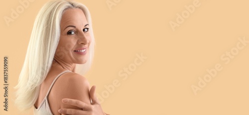 Mature blonde woman on beig...