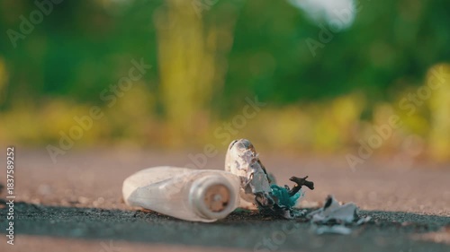 Close-Up: Hands in Blue Latex Gloves Sweeping Plastic Waste with Dustpan and Brush on Asphalt | Environmental Cleanup Action During Golden Hour Sunset | Street Litter Removal