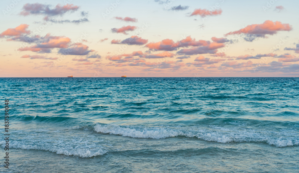 Fototapeta premium Romantic summer vacation on sunset seascape. Sea sunset on ocean. Sunset seascape at summer vacation. Sunrise with sea beach. Dramatic sunrise horizon at sea. Sea waves
