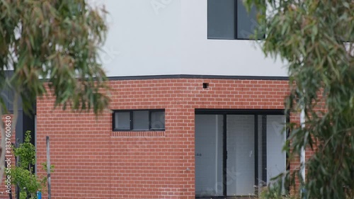 A newly constructed two-storey townhouse in suburban Australia. Concept of modern residential development, new housing estates, suburban growth