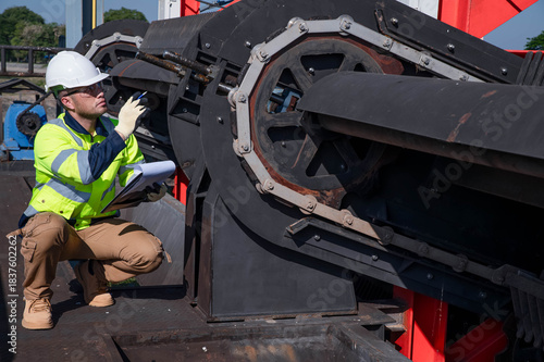 A specialist inspector is inspecting a waste scoop at a wastewater treatment plant.