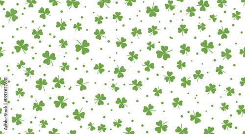 Simple St. Patrick's Day seamless pattern with green three-leaf clovers and dots scattered on a white background for good luck.