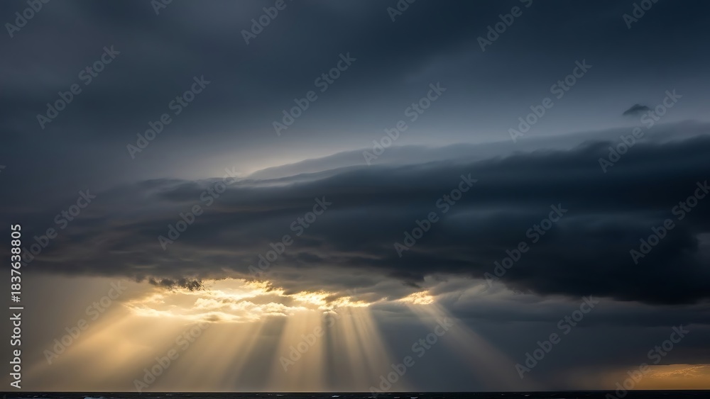 Obraz premium Dramatic Sky with Sun Rays Piercing Through Dark Clouds.