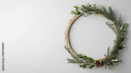 Winter greenery wreath with pinecone and mixed foliage, festive natural decor