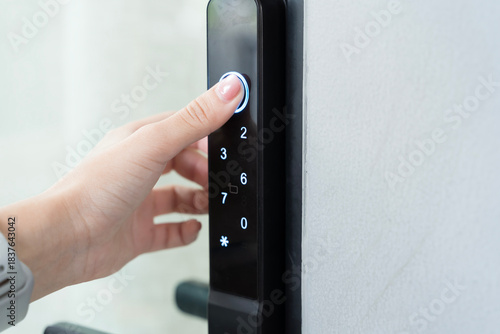 Hand pressing smart digital door lock keypad for secure access modern home technology safety and convenience