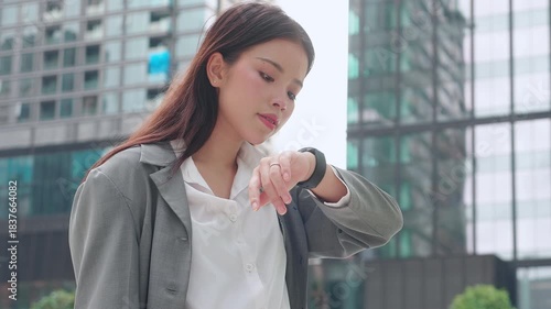 Young asian businesswoman using voice recording or speech recognition technology in smartwatch for voice command with AI, business woman talking to mic and recorder of smartwatch, virtual assistant.