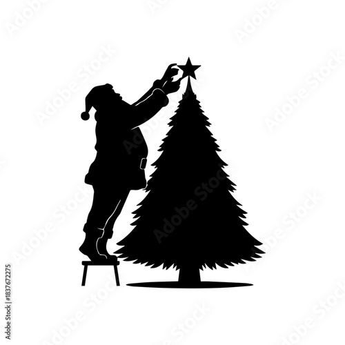 Santa placing a star on top of a tree silhouette