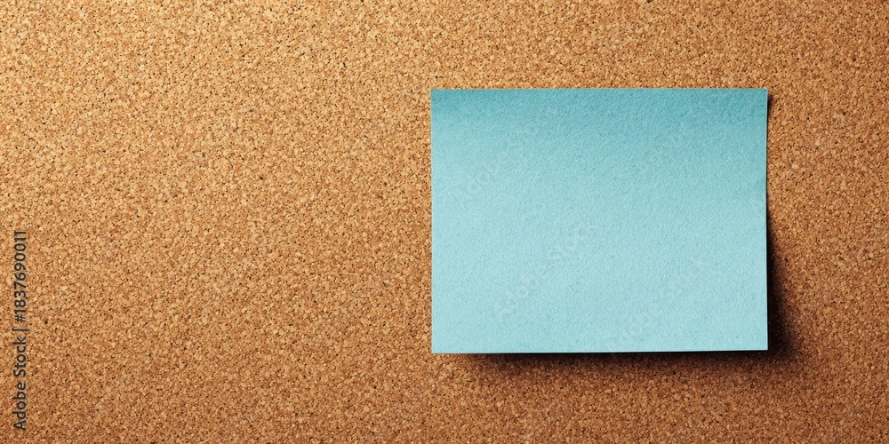 Fototapeta premium The Blue Sticky Note On A Cork Bulletin Board With Blank Copyspace For Message