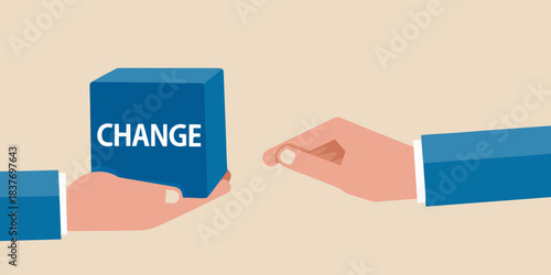 Hands exchanging a blue block with the word change written on it