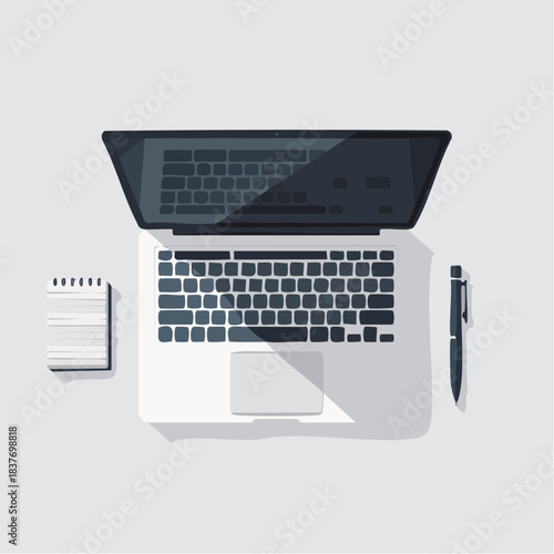 Modern laptop with notepad and pen from above.