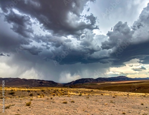 Dramatic landscape shot with approaching storm clouds over distant mountains