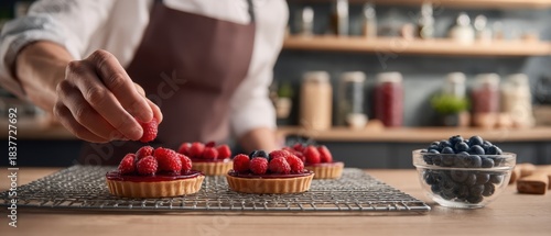 The Raspberry Tart Chef Arranging Fresh Berries on Homemade Pastry in Rustic Kitchen