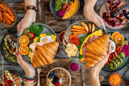 Croissant sandwich filled with ham, bacon, cheese and salad.  crowich