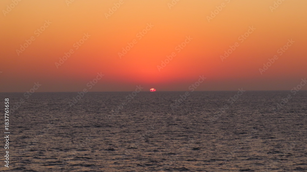 Fototapeta premium Beautiful Sunrise Appearing on the Ocean Horizon Viewed from Ferry Deck