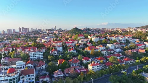 Aerial View of Qingdao Cityscape with Red Roofs and Green Vegetation