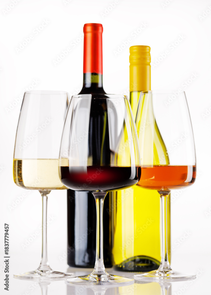 Fototapeta premium Different wine bottles and glasses on white background