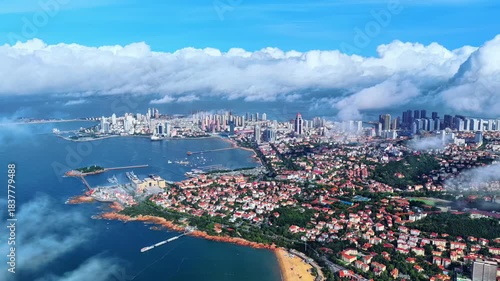 Aerial View of Qingdao Coastal City with Blue Waters and Clouds