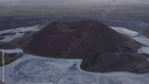 Aerial view of volcanic cone with crater and dried lake at sunset, Turkey