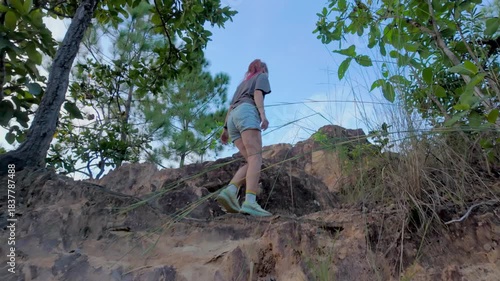 Low Angle View Pink-Haired Hiker Scrambling Up Rocky Hill