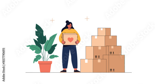 Woman holding a charity donation box with a heart symbol standing next to a houseplant and a large stack of moving boxes.