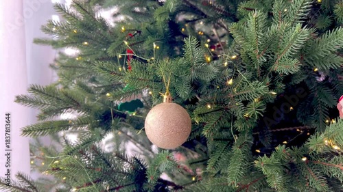 Cozy green Christmas tree at home decorated with fairy ornaments and glowing lights. Festive holiday atmosphere, warm interior, traditional New Year celebration, magical winter mood