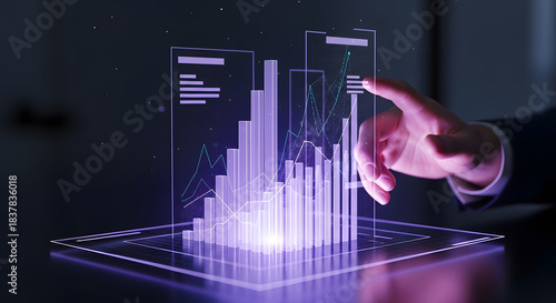 A person's hand interacting with a futuristic holographic display showing financial charts and data.