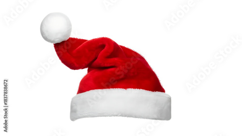 A plush red and white furry Santa Claus hat on a black background, essential holiday symbol.