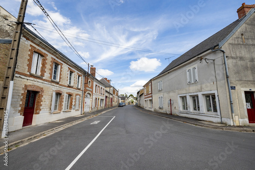 Asfeld, Church Saint-Didier, Rethel, Ardennes, Grand-Est, France, August, 28th, 2025, Quiet street with stone houses, Peaceful country road bordered by symmetrical stone residences and shuttered