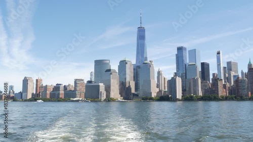 New York City Manhattan Downtown Financial District skyline, World Trade Center tower from ferry boat to New Jersey, United States of America. River waterfront urban cityscape with skyscraper building