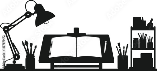 Black silhouette of an artist's desk with an open sketchbook lamp and art supplies drawing painting