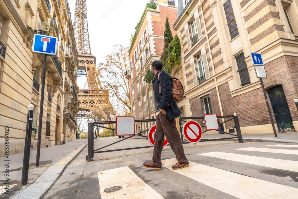 Obraz premium Person walking on crosswalk in autumn paris