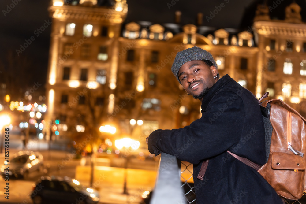 Fototapeta premium Young man smiling at night in paris city