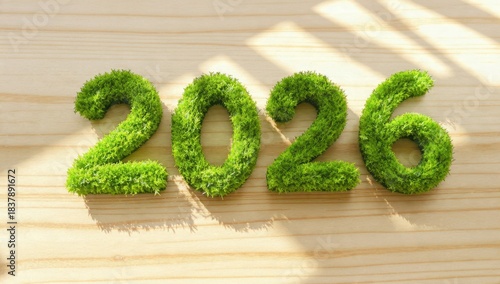 2026 eco-friendly concept made of vibrant green moss and natural grass texture, displayed on a bright pine wood surface with sunlit diagonal shadows, symbolizing sustainable future and new beginnings.