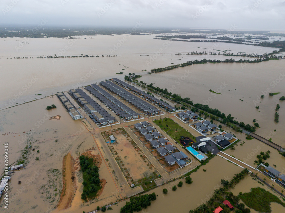 Naklejka premium Severe Flooding on Lupburi Ramesuan Road in Hat Yai, Thailand, with Highway Submerged Under Turbid Water