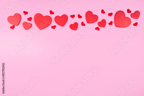 Valentine day pink greeting card background with red hearts