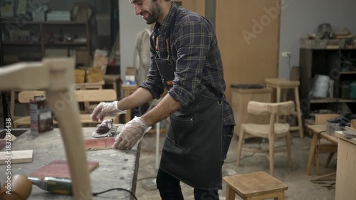 Carpenter is working at workshop. Small business and craft product.