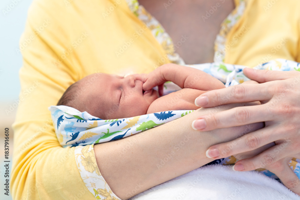 Fototapeta premium Mother, holding tenderly her newborn baby boy. Closeup portrait