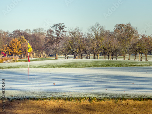 Frosty Golf Green with Flag on a Clear Winter Morning