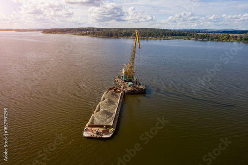 Obraz na plátně Cleaning the river bottom with a crane and a barge top view