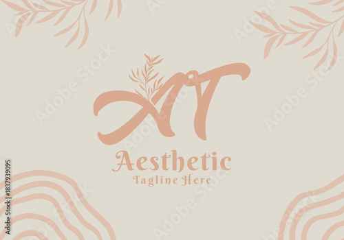 Brush style AT initial letter logo with aesthetic leaf accents