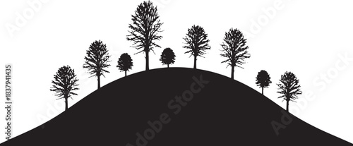 Silhouette of bare trees on a rolling hill winter