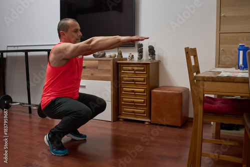 Man doing bodyweight squats at home