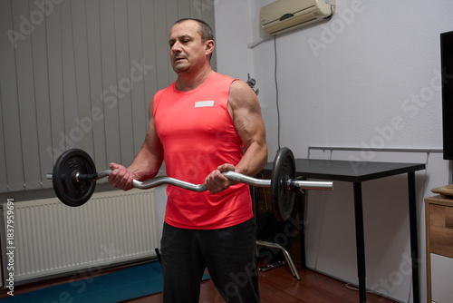 Man doing biceps curls with EZ bar