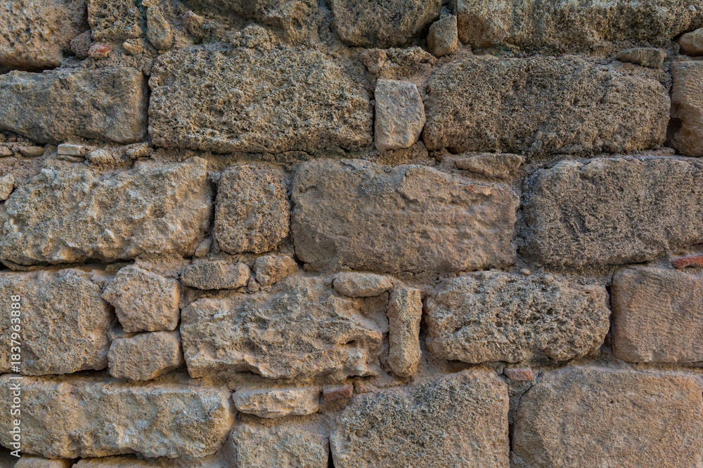 Obraz premium Rough Stone Wall Texture With Weathered Surface Old Masonry Detail Background Pattern