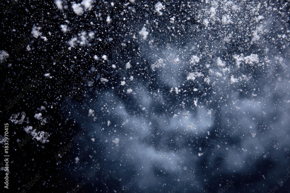 Obraz premium A dark, blurry close-up showcases falling snowflakes, with light reflecting off them in the air
