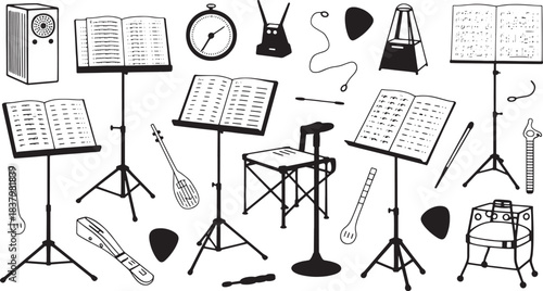 Collection of black and white musical instruments and accessories on white background sheet music metronome