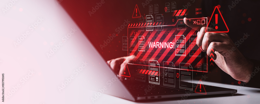 Naklejka premium Cybersecurity warning alert on digital screen with hands typing on laptop, concept of data breach and malware attack on dark red background.